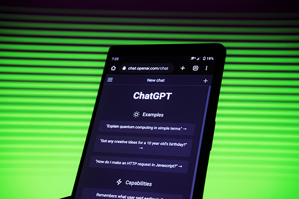 A phone screen displays the text "ChatGPT"