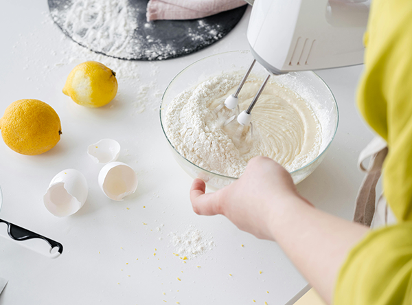 A person uses an electric mixer