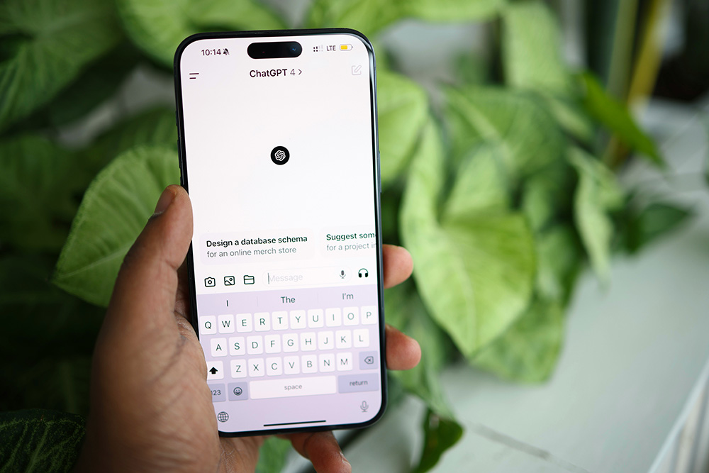 a phone screen displays the ChatGPT website