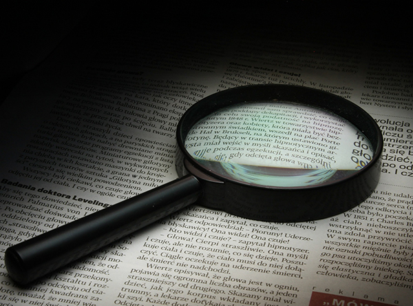 Magnifying glass on newspaper