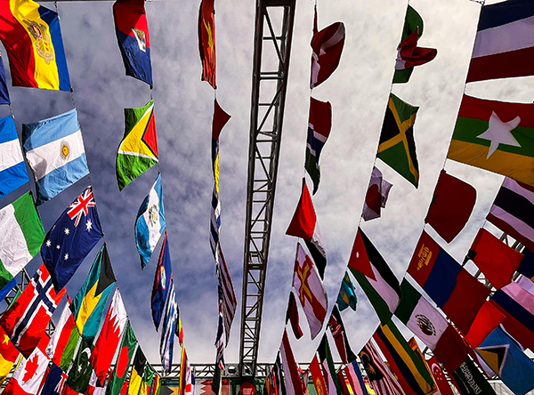 various flags of different countries hang from ropes