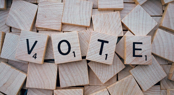 Scrabble letters spelling VOTE