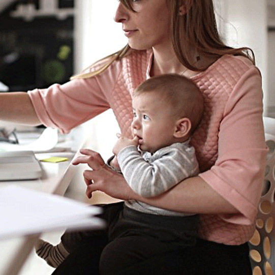 person with baby at computer