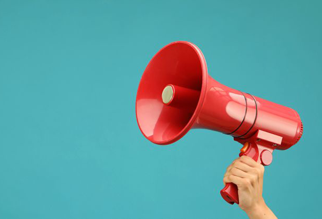 A hand holds a megaphone