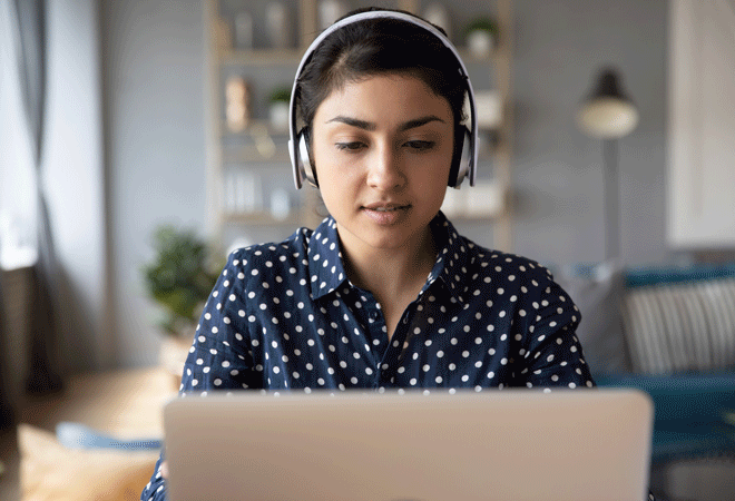 Person at computer wearing headphones