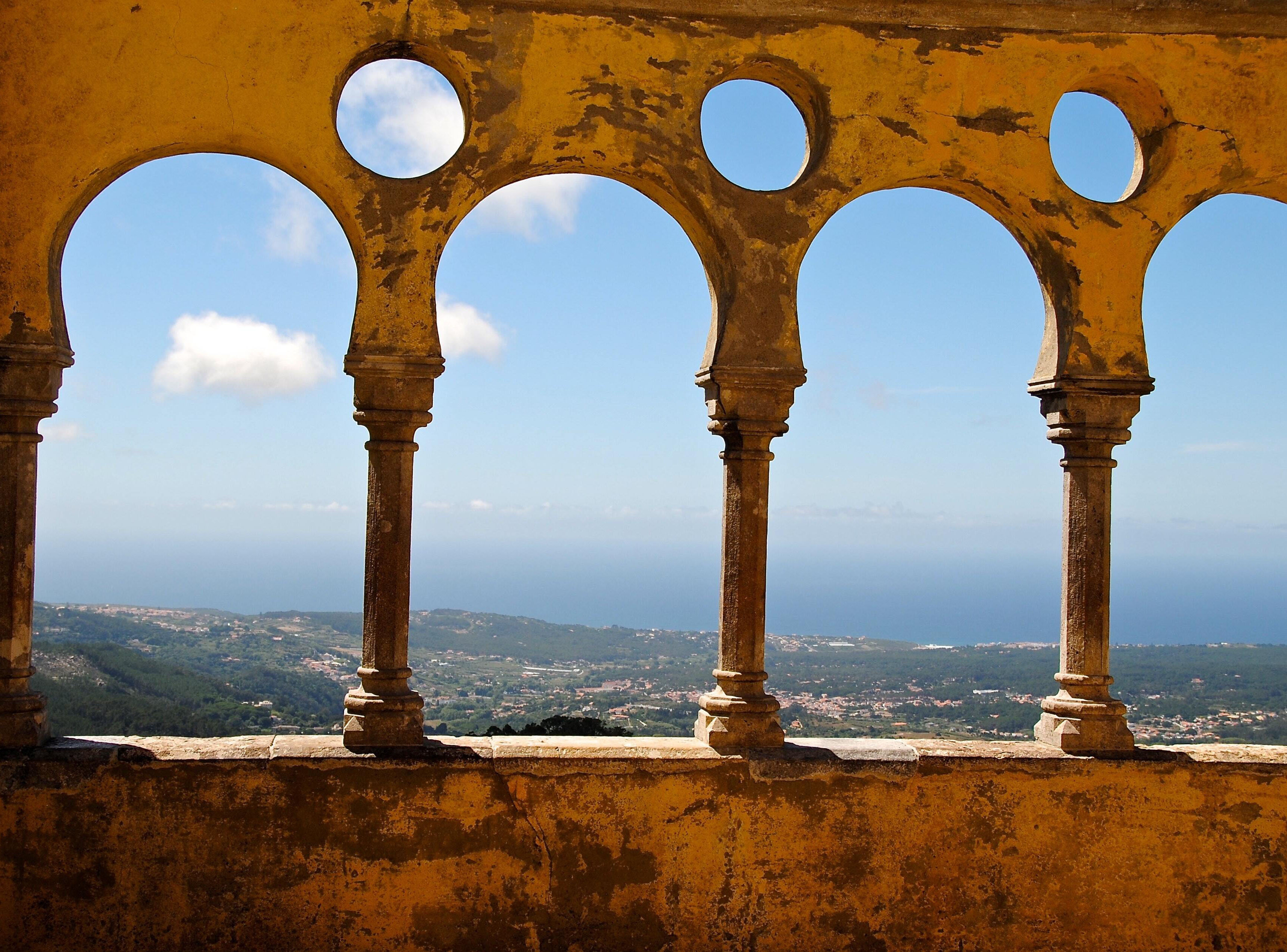 Azure sky and coastline framed by ancient columns 