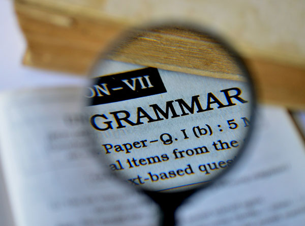 The word grammar enlarged by a magnifying glass