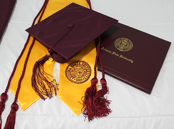 A graduation cap, tassels, and a diploma