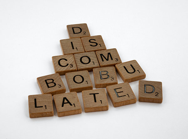 A pyramid of Scrabble letters spelling out the word "discombobulated."